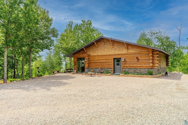2137 Deer Ridge Rd, Ely, MN 55731 - log-style house featuring stone siding, driveway, and log siding