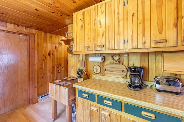 3666 Mackie Rd, Ely, MN 55731 - kitchen featuring wooden walls, wood ceiling, blue cabinets, and light wood-style flooring