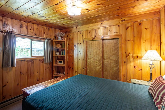 3666 Mackie Rd, Ely, MN 55731 - bedroom with wooden walls, baseboard heating, wooden ceiling, and a closet
