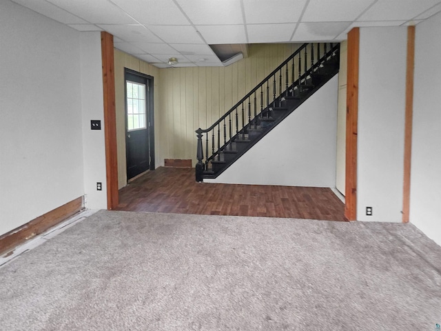 3756 Main St, Barnum, MN 55707 - carpeted entryway with a paneled ceiling, stairway, and wood walls