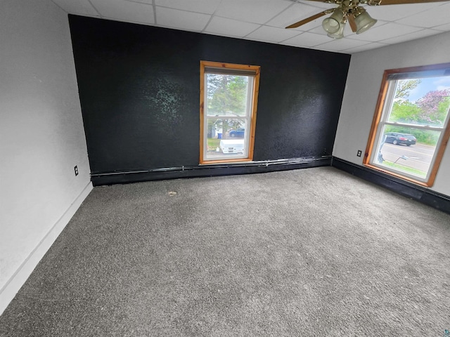 3756 Main St, Barnum, MN 55707 - carpeted empty room featuring a paneled ceiling, a ceiling fan, baseboards, and a textured wall