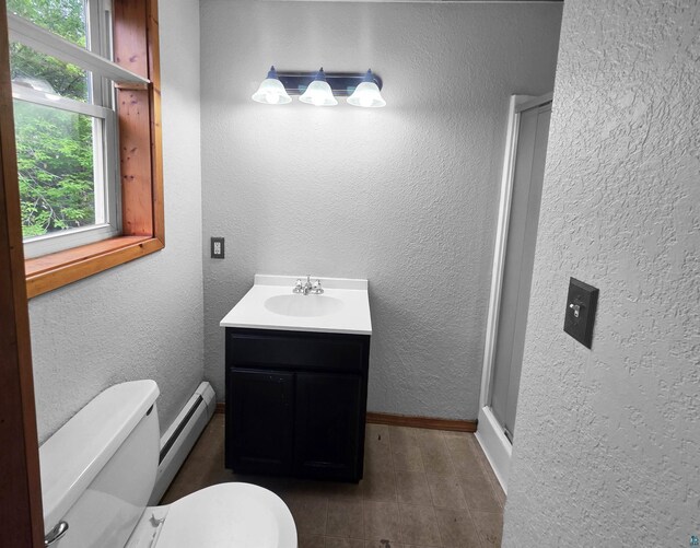 3756 Main St, Barnum, MN 55707 - bathroom with toilet, vanity, baseboard heating, baseboards, and a shower