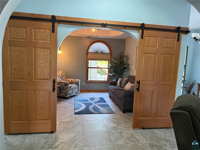 58950 State Highway 23, Sandstone, MN 55072 - living room with a barn door, arched walkways, and baseboards