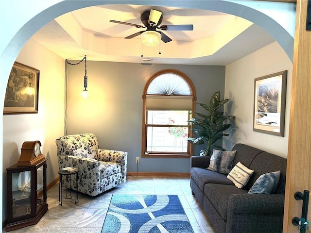 58950 State Highway 23, Sandstone, MN 55072 - living area with ceiling fan, a raised ceiling, and baseboards