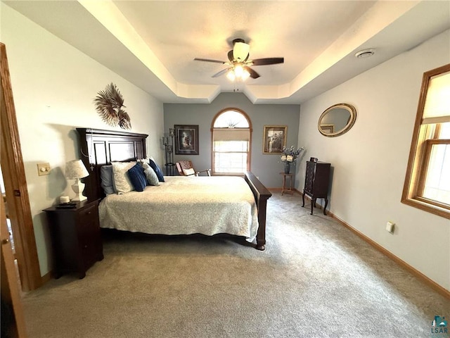 58950 State Highway 23, Sandstone, MN 55072 - bedroom with a raised ceiling, light colored carpet, baseboards, and ceiling fan