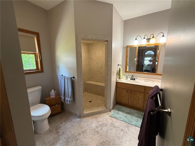 58950 State Highway 23, Sandstone, MN 55072 - bathroom featuring toilet, a tile shower, vanity, and tile patterned floors
