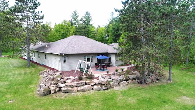 58950 State Highway 23, Sandstone, MN 55072 - rear view of house with a patio, a yard, and a shingled roof