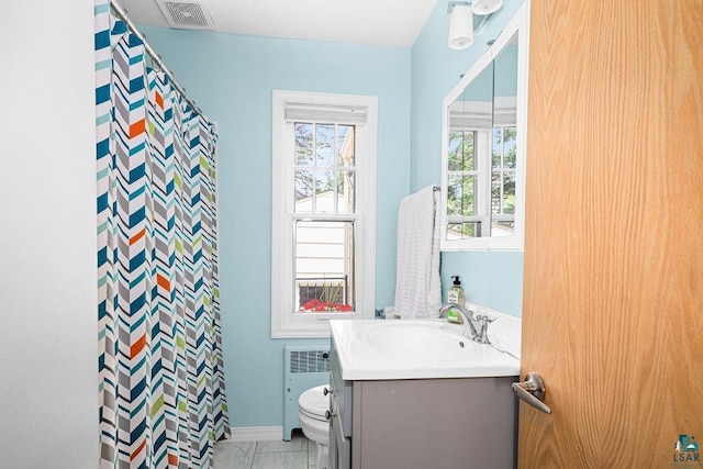 3319 E Superior St, Duluth, MN 55804 - bathroom with vanity, radiator, toilet, a shower with shower curtain, and marble look tiles