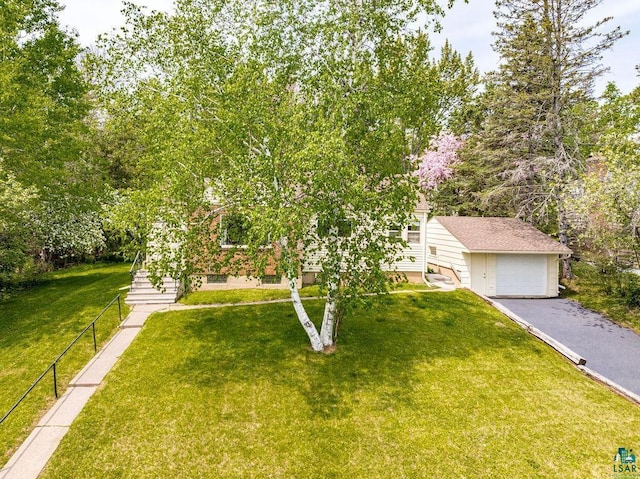 3319 E Superior St, Duluth, MN 55804 - view of property hidden behind natural elements with driveway, a detached garage, and an outbuilding