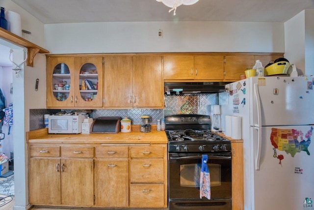 316 W 3rd Ave N, Aurora, MN 55705 - kitchen featuring white appliances, under cabinet range hood, tasteful backsplash, light countertops, and brown cabinetry