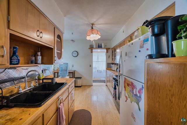 316 W 3rd Ave N, Aurora, MN 55705 - kitchen with a sink, white appliances, tasteful backsplash, light wood-style flooring, and light countertops