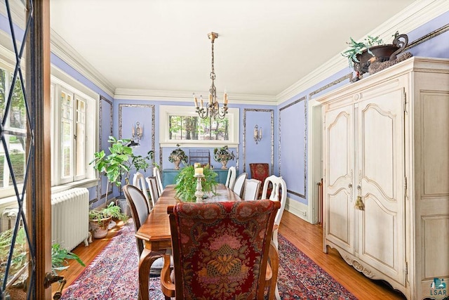 2401 E 5th St, Duluth, MN 55812 - dining area featuring radiator, a chandelier, light wood finished floors, and crown molding
