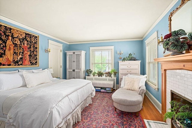 2401 E 5th St, Duluth, MN 55812 - bedroom with wood finished floors, a brick fireplace, baseboards, and crown molding