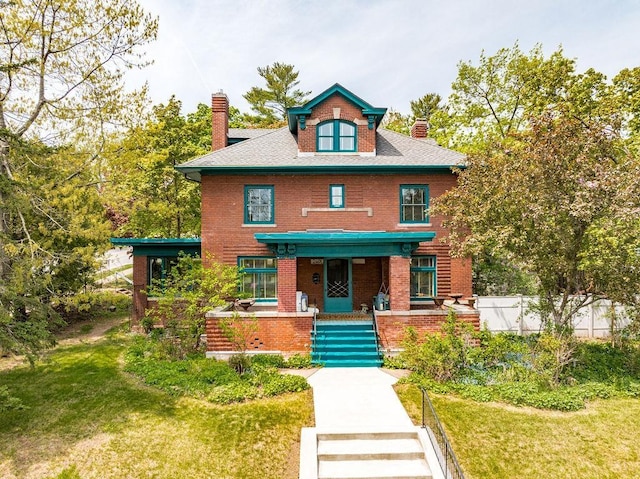 2401 E 5th St, Duluth, MN 55812 - traditional style home featuring a chimney, a front lawn, a porch, brick siding, and stairs