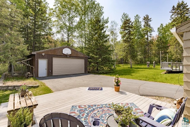609 N 34th Ave E, Duluth, MN 55804 - view of patio with a garage, an outbuilding, a deck, and view of wooded area