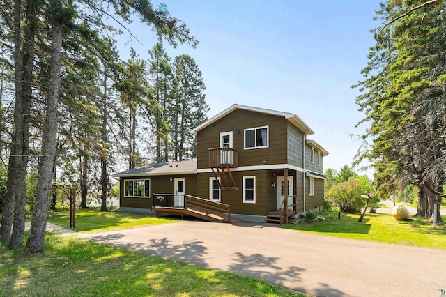 244 E 3rd St, Knife River, MN 55609 - view of front of property featuring a front lawn, a balcony, and a deck
