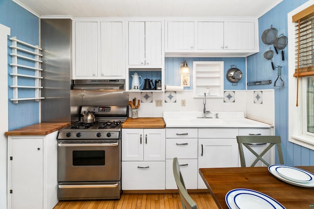 244 E 3rd St, Knife River, MN 55609 - kitchen with stainless steel range with gas cooktop, wooden counters, open shelves, under cabinet range hood, and a sink