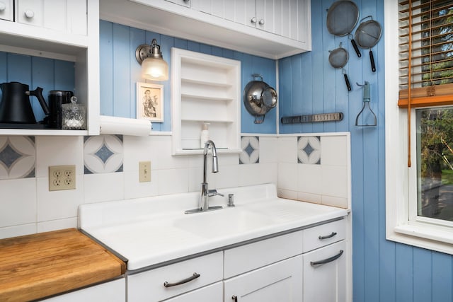 244 E 3rd St, Knife River, MN 55609 - kitchen featuring decorative backsplash, a sink, open shelves, white cabinets, and light countertops