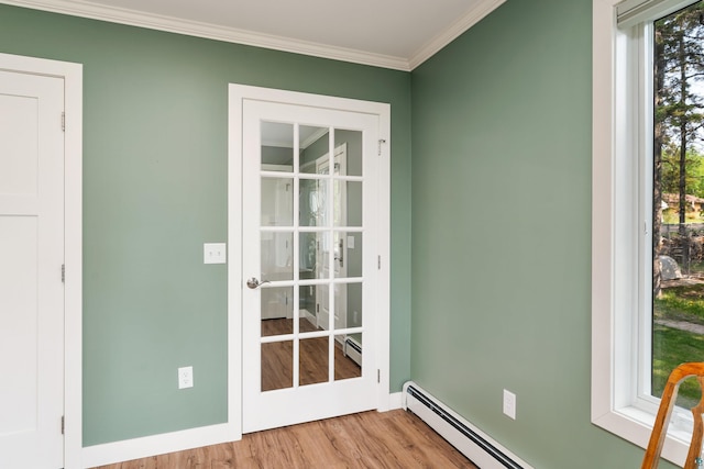244 E 3rd St, Knife River, MN 55609 - doorway with wood finished floors, crown molding, and a baseboard heating unit
