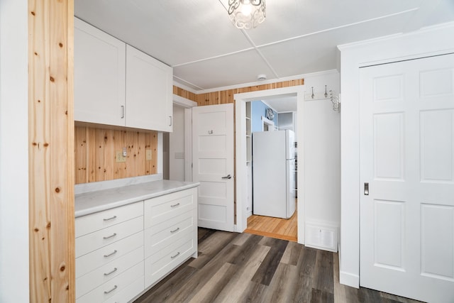 244 E 3rd St, Knife River, MN 55609 - kitchen featuring freestanding refrigerator, light countertops, white cabinets, dark wood finished floors, and wood walls
