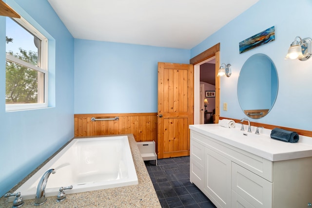 244 E 3rd St, Knife River, MN 55609 - full bathroom with vanity, a garden tub, wainscoting, and wooden walls