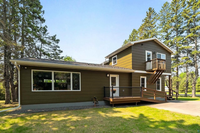 244 E 3rd St, Knife River, MN 55609 - back of property with a balcony, a yard, a wooden deck, and roof with shingles