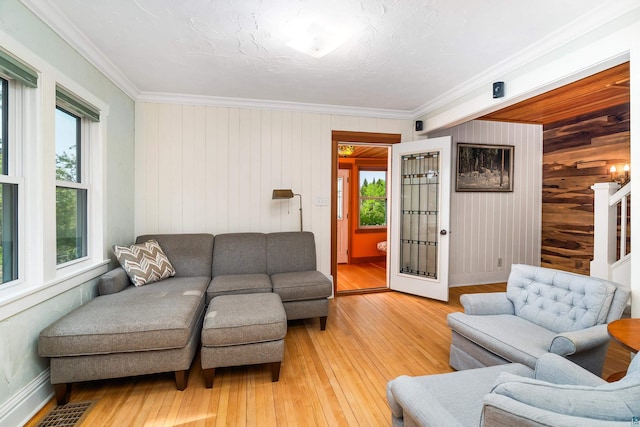 244 E 3rd St, Knife River, MN 55609 - living room with plenty of natural light, wooden walls, light wood-type flooring, crown molding, and baseboards