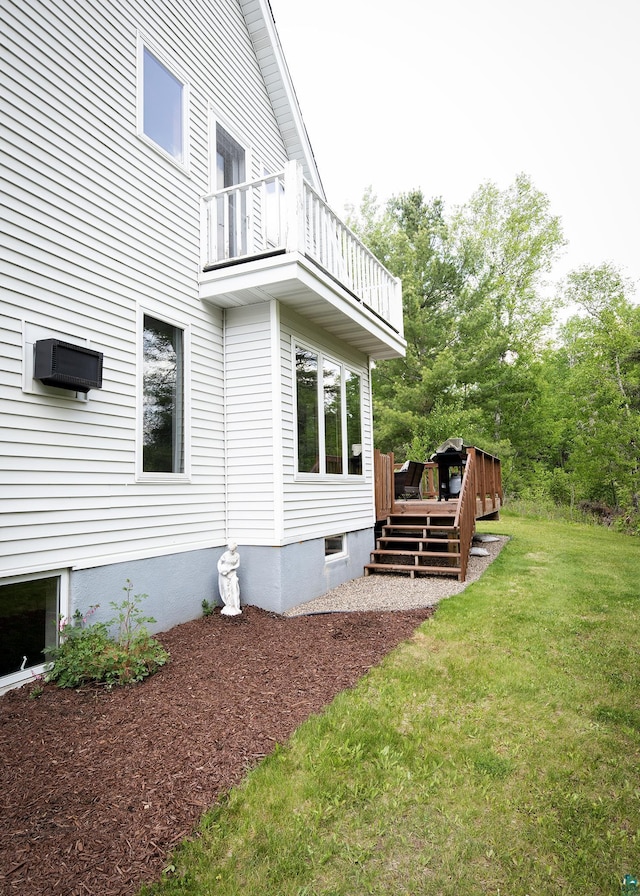 6220 N Tischer Rd, Duluth, MN 55804 - view of side of property featuring a balcony, a lawn, and a wooden deck
