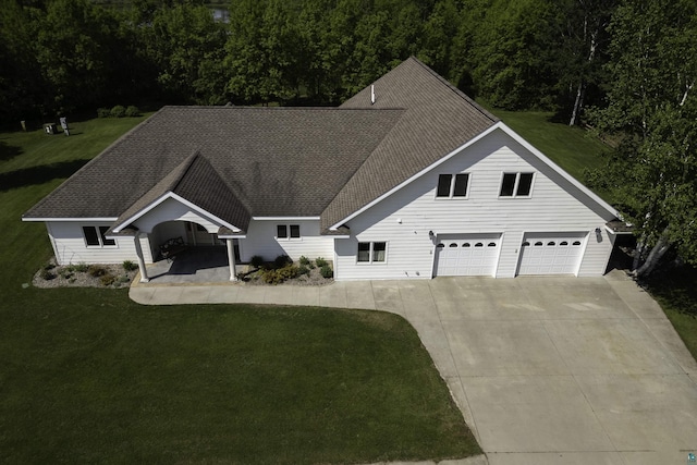 20 Mulberry Ln, Babbitt, MN 55731 - view of front of property with a front lawn, driveway, a garage, and roof with shingles
