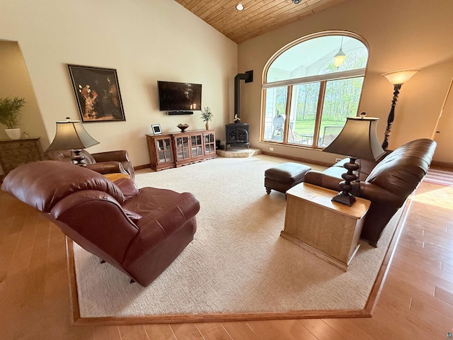 20 Mulberry Ln, Babbitt, MN 55731 - living area with a wood stove, wooden ceiling, high vaulted ceiling, hardwood / wood-style flooring, and baseboards
