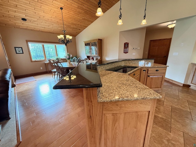 20 Mulberry Ln, Babbitt, MN 55731 - kitchen with black electric stovetop, wooden ceiling, baseboards, high vaulted ceiling, and light stone counters