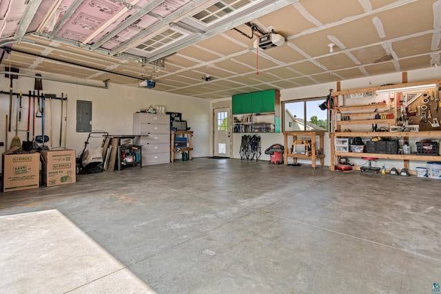 38006 Harvester Ave, North Branch, MN 55056 - garage with electric panel, a garage door opener, and a workshop area