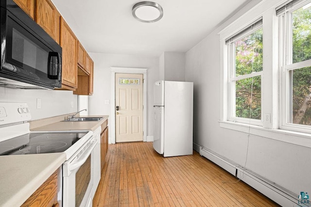 1901 E 5th St, Duluth, MN 55812 - kitchen with white appliances, a baseboard radiator, brown cabinets, a sink, and light countertops
