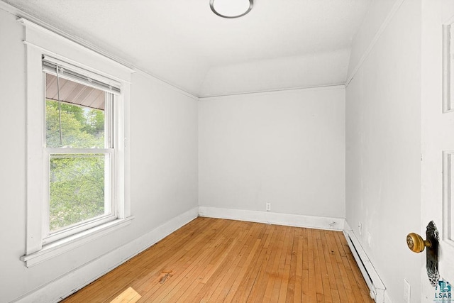 1901 E 5th St, Duluth, MN 55812 - empty room featuring a baseboard heating unit, healthy amount of natural light, and light wood-style flooring