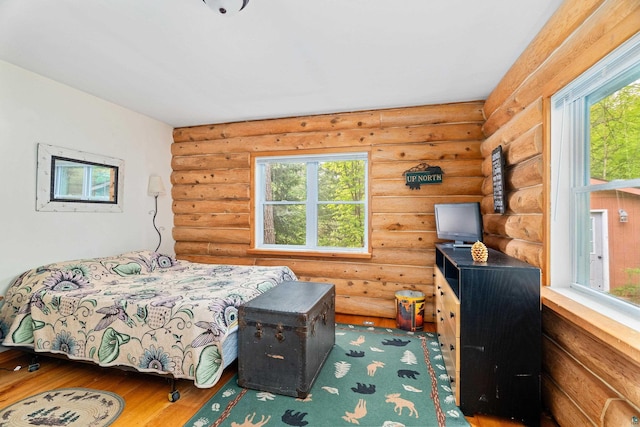 204 E Deeryard Rd, Grand Marais, MN 55604 - bedroom with log walls and hardwood / wood-style floors