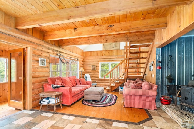 204 E Deeryard Rd, Grand Marais, MN 55604 - living room with a wood stove, stairway, rustic walls, and wood ceiling with exposed beams