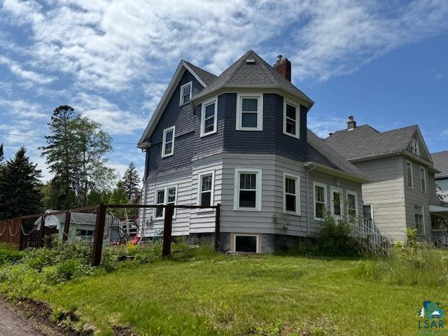 17 S 57th Ave E, Duluth, MN 55804 - view of property exterior with a chimney and a yard