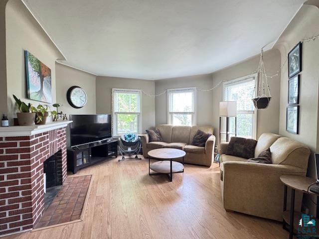 17 S 57th Ave E, Duluth, MN 55804 - living room with light wood-type flooring, plenty of natural light, and a brick fireplace