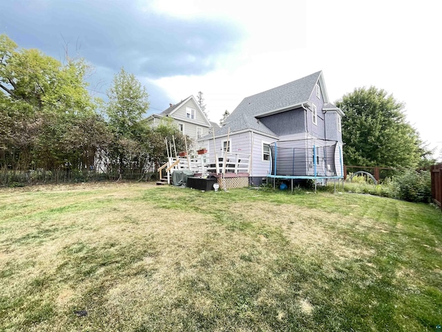17 S 57th Ave E, Duluth, MN 55804 - back of house with a trampoline, a deck, and a shingled roof