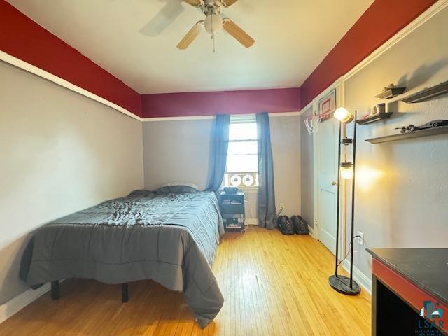 17 S 57th Ave E, Duluth, MN 55804 - bedroom featuring wood finished floors, baseboards, and a ceiling fan