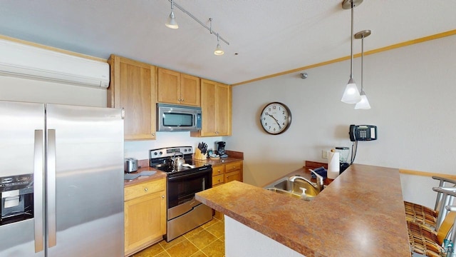 21 E Wisconsin St Unit 302, Grand Marais, MN 55604 - kitchen with appliances with stainless steel finishes, a sink, pendant lighting, a peninsula, and a wall unit AC