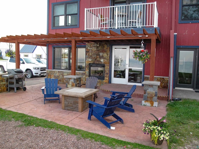 21 E Wisconsin St Unit 302, Grand Marais, MN 55604 - view of patio featuring a balcony, an outdoor fire pit, area for grilling, and a pergola