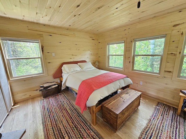 839 Loon Rd, Two Harbors, MN 55616 - bedroom featuring wooden walls, light wood-type flooring, and wood ceiling