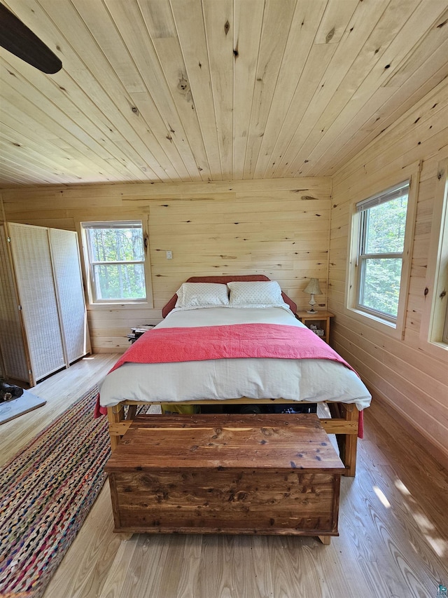 839 Loon Rd, Two Harbors, MN 55616 - bedroom with wood finished floors, wooden walls, wooden ceiling, and multiple windows
