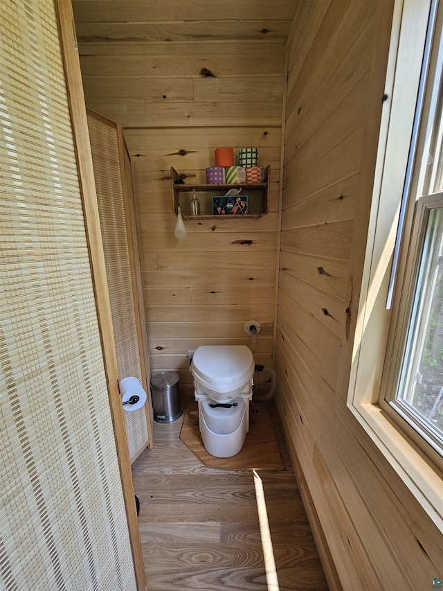 839 Loon Rd, Two Harbors, MN 55616 - bathroom featuring wooden walls, toilet, and wood finished floors