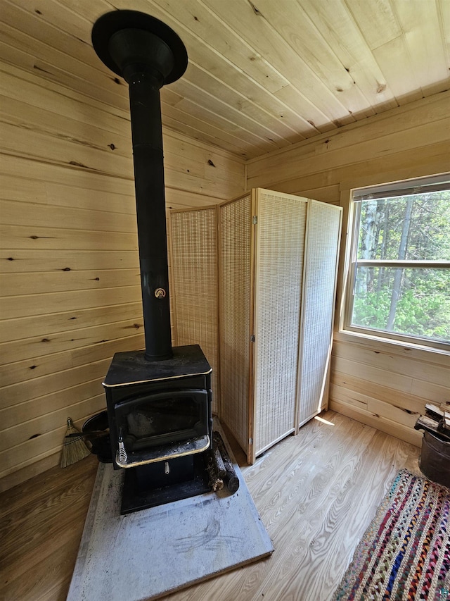 839 Loon Rd, Two Harbors, MN 55616 - detailed view of a wood stove, wooden walls, wood finished floors, and wood ceiling