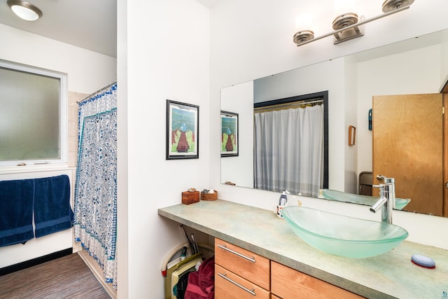 14 W 5th St Unit 1, Duluth, MN 55806 - full bathroom with vanity, a shower with curtain, and wood finished floors