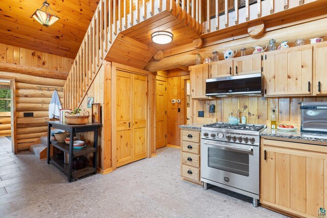 1543 E Miners Lk, Ely, MN 55731 - kitchen with stainless steel appliances, light brown cabinetry, log walls, light stone countertops, and range hood