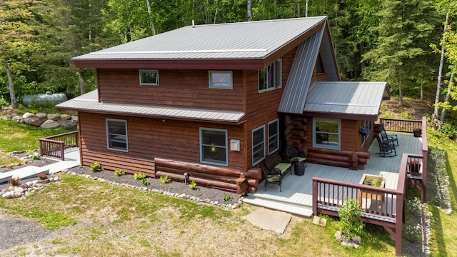 1543 E Miners Lk, Ely, MN 55731 - back of property with a deck, metal roof, and a view of trees