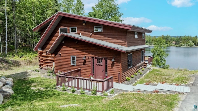 1543 E Miners Lk, Ely, MN 55731 - view of front of house with a deck with water view and a front lawn